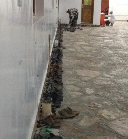 See that man on the left, in chequered shirt, bent over.
That’s him almost done arranging the many, many sandals and s…